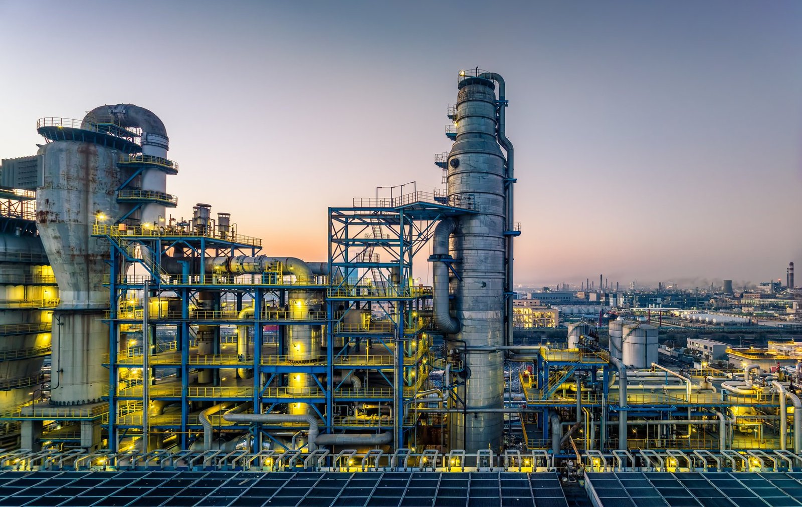 Illuminated chemical plant and oil and gas infrastructure at twilight