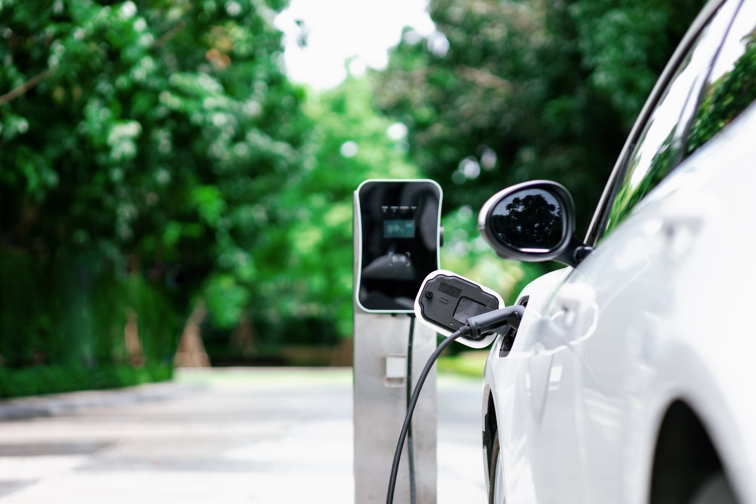 Electric vehicle charging close-up with blurred mobility infrastructure